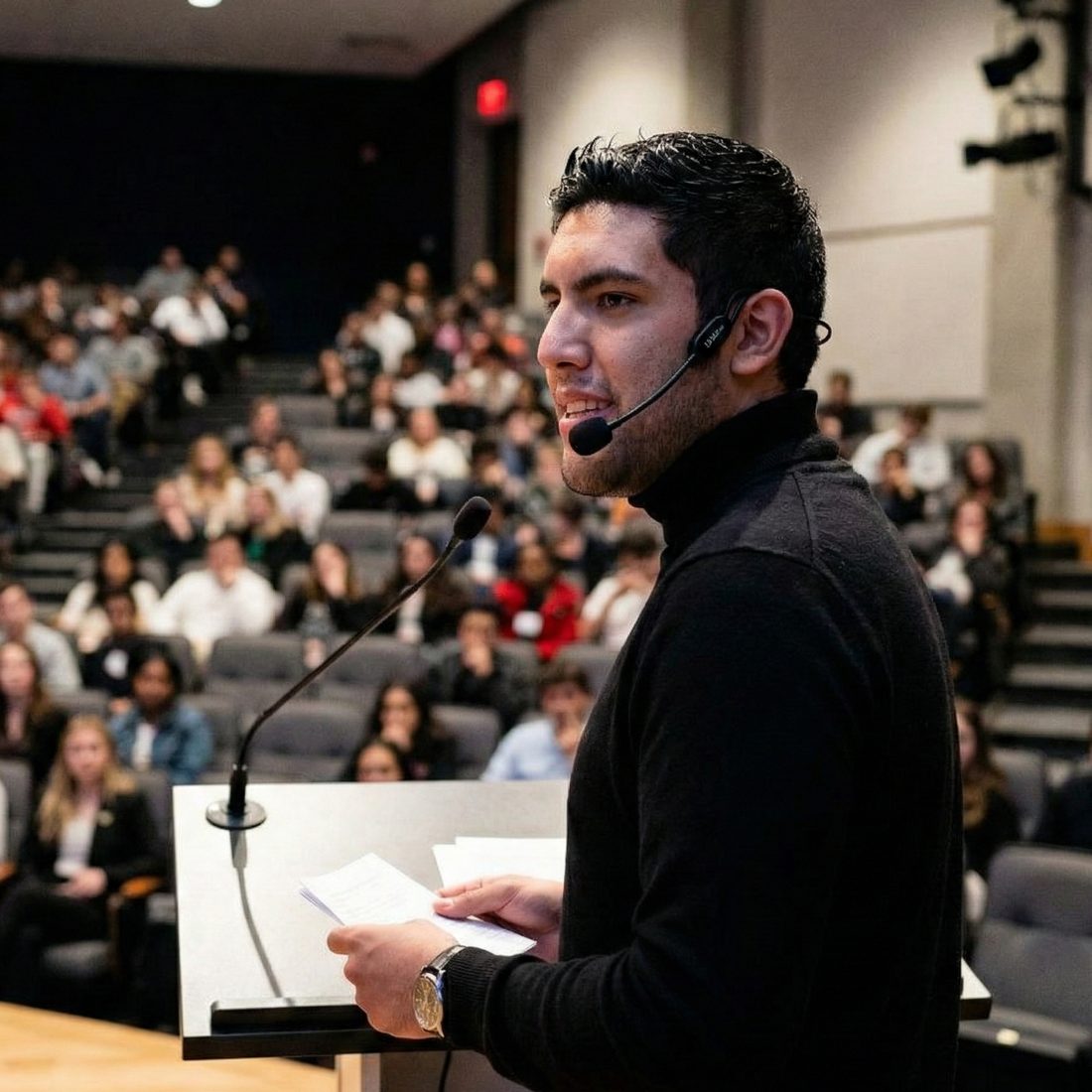 Christian Martinez giving a lecture to a full auditorium